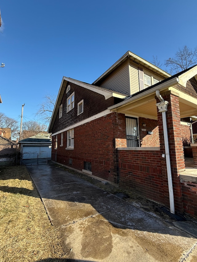 view of side of home with a garage and an outbuilding