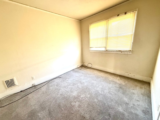 spare room with visible vents and carpet floors