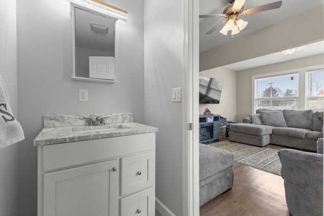 bathroom with vanity, hardwood / wood-style floors, and ceiling fan