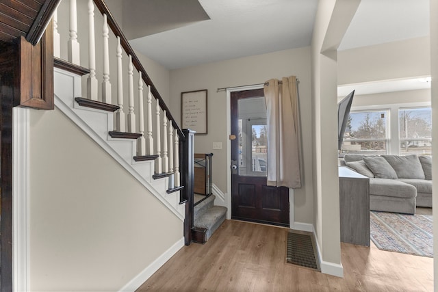 foyer entrance with light hardwood / wood-style floors