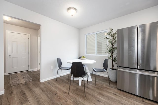 dining space with hardwood / wood-style flooring