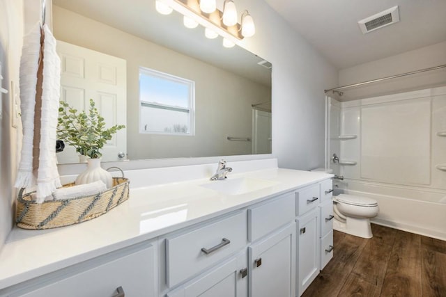 full bathroom with hardwood / wood-style flooring, shower / tub combination, vanity, and toilet