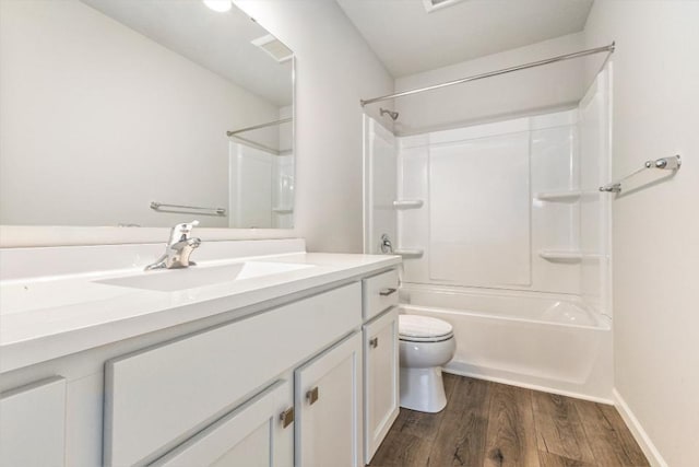 full bathroom with vanity, hardwood / wood-style floors, shower / tub combination, and toilet