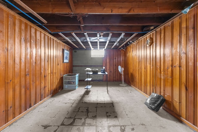 basement featuring wooden walls