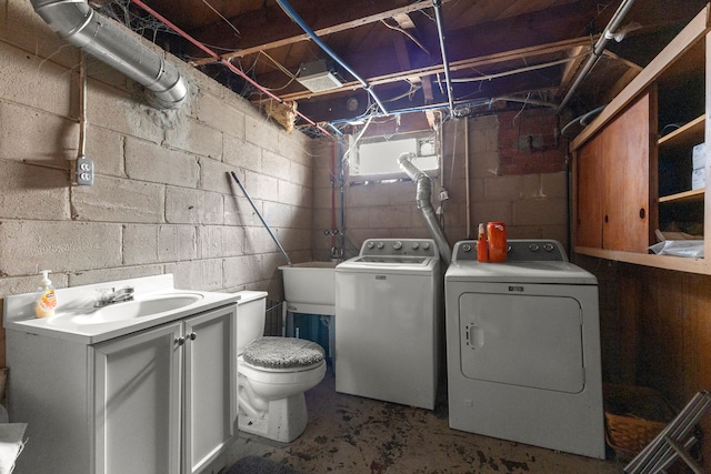 washroom featuring washing machine and dryer and sink