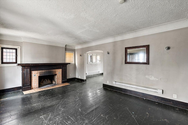 unfurnished living room featuring a fireplace, dark hardwood / wood-style floors, a textured ceiling, and baseboard heating