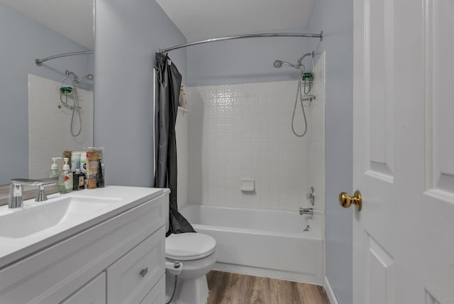 full bathroom with vanity, wood-type flooring, toilet, and shower / bath combo with shower curtain