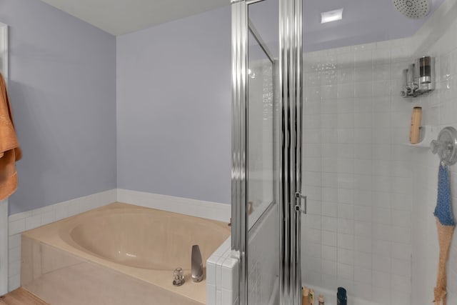 bathroom featuring shower with separate bathtub