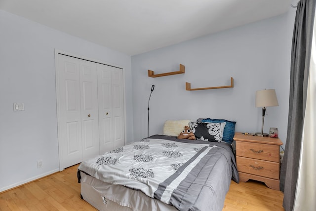 bedroom with a closet and light hardwood / wood-style flooring