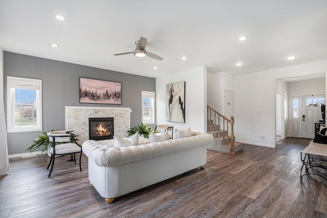 living room featuring ceiling fan and dark hardwood / wood-style floors