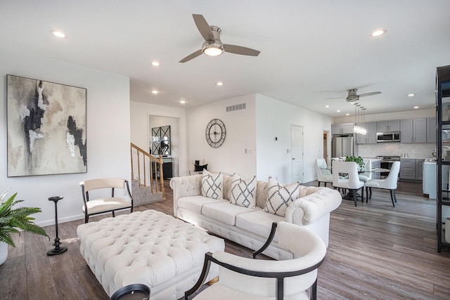 living room with hardwood / wood-style flooring and ceiling fan