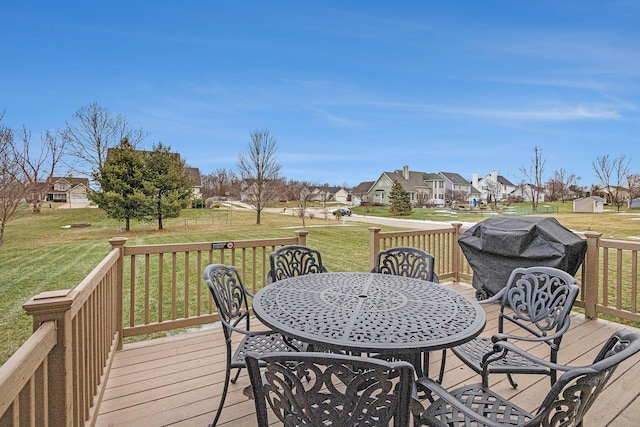 deck with area for grilling and a lawn