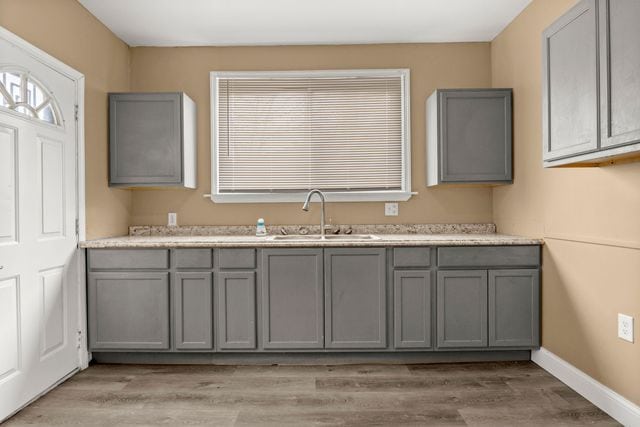 kitchen featuring light hardwood / wood-style flooring, sink, and gray cabinets