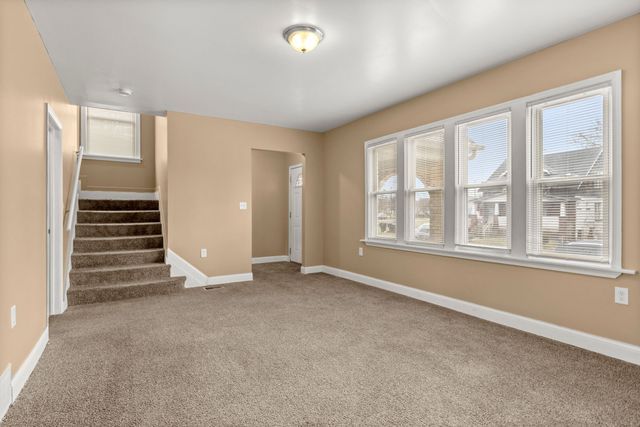 unfurnished living room with carpet flooring