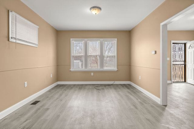 unfurnished room with light hardwood / wood-style floors