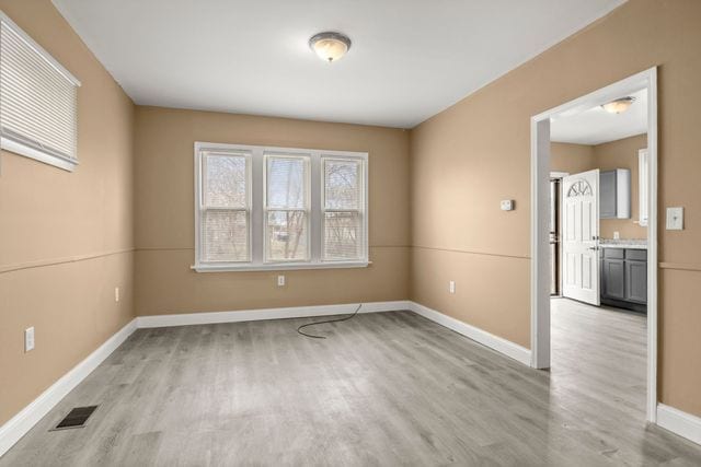 spare room featuring light hardwood / wood-style flooring