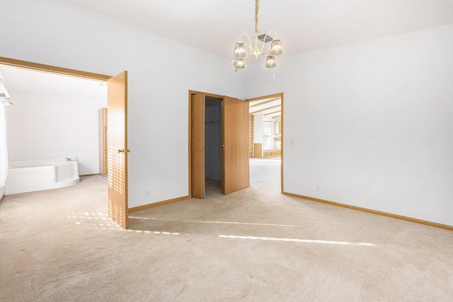 empty room with carpet floors and a chandelier