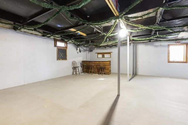 basement featuring indoor bar