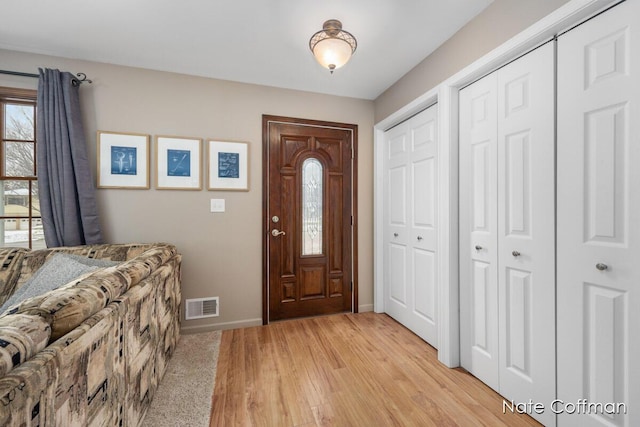 foyer with light hardwood / wood-style floors