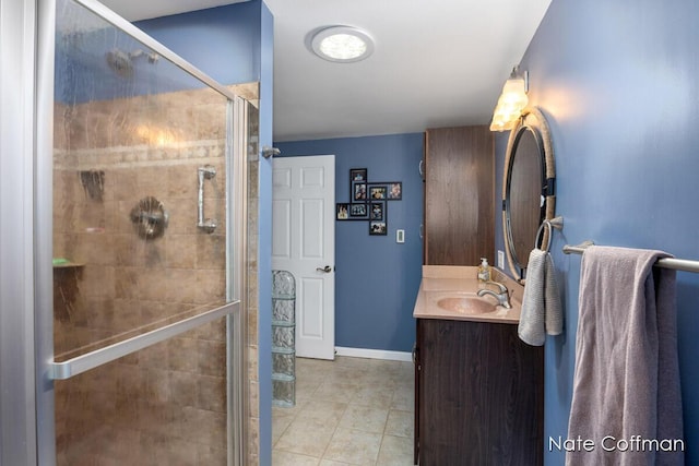 bathroom with walk in shower, tile patterned floors, and vanity