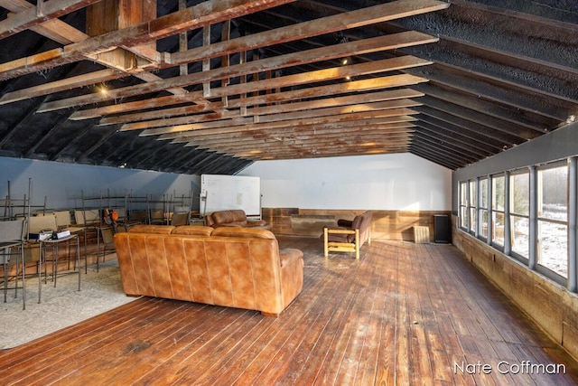 living room with hardwood / wood-style flooring and vaulted ceiling