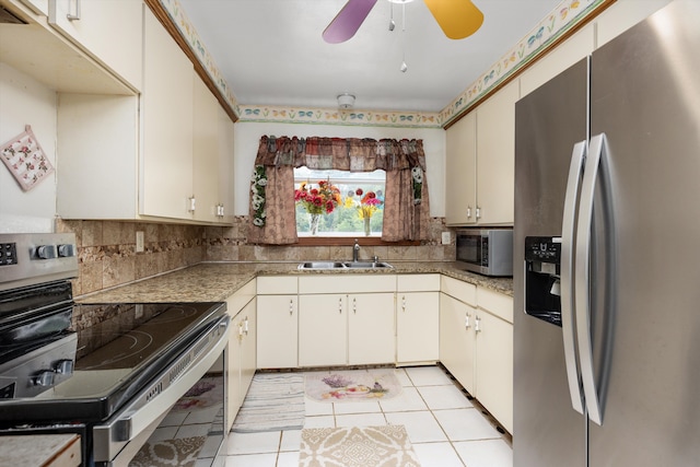 kitchen featuring cream cabinets, appliances with stainless steel finishes, sink, and decorative backsplash