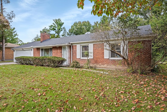 ranch-style house featuring a garage and a front yard