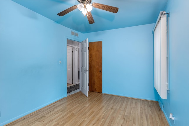 spare room with ceiling fan and light wood-type flooring