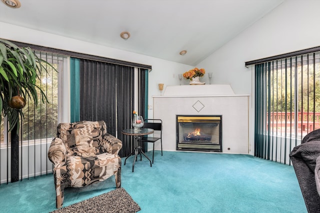 sitting room with vaulted ceiling, plenty of natural light, and carpet flooring