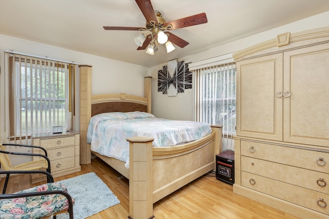 bedroom with ceiling fan and light wood-type flooring