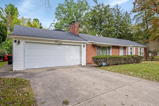 single story home featuring a garage and a front yard