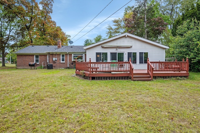 rear view of house featuring central AC, a yard, and a deck