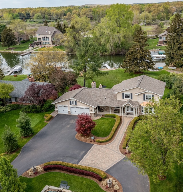 birds eye view of property with a water view