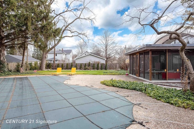 view of pool featuring a patio and a sunroom