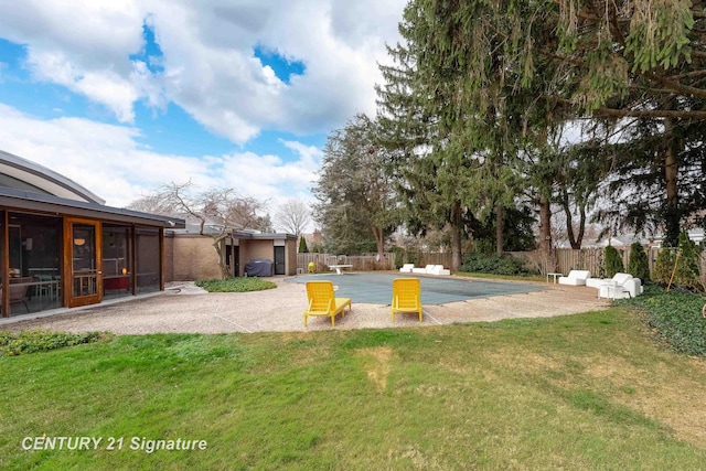 view of yard with a patio area, a sunroom, and a covered pool