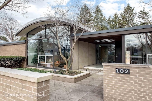 view of exterior entry with a carport