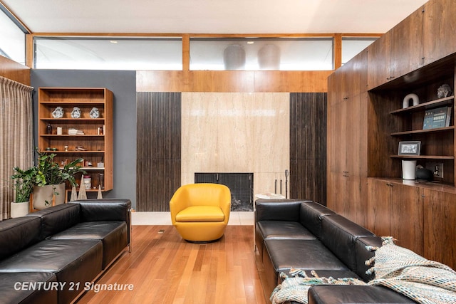 living room featuring built in shelves and light hardwood / wood-style floors