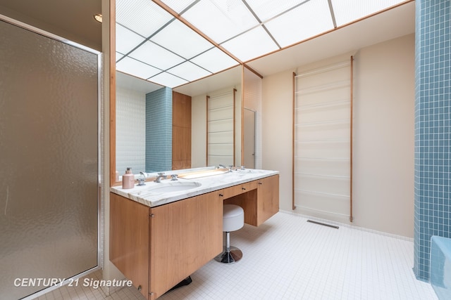 bathroom featuring vanity and a shower with shower door