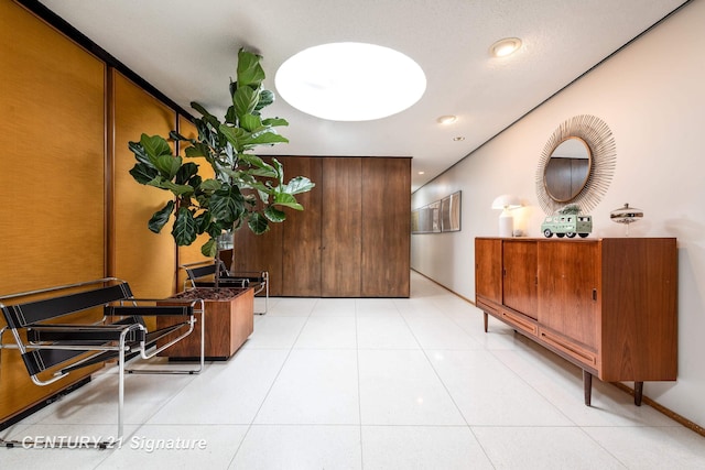 corridor featuring light tile patterned floors