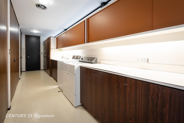 washroom featuring cabinets and washer and dryer