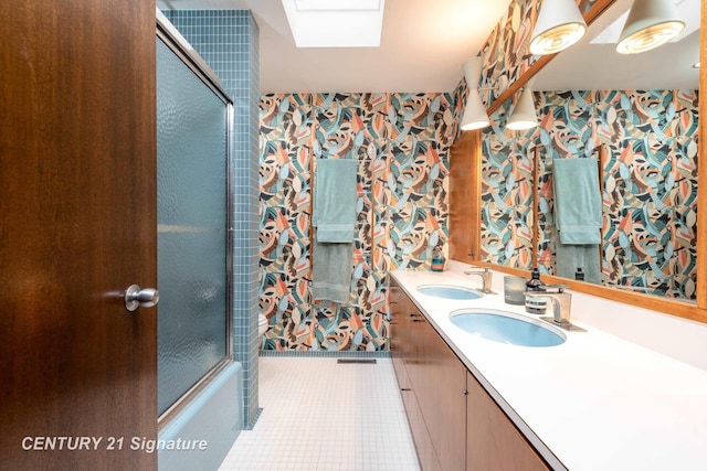 bathroom with vanity, shower / bath combination with glass door, and tile patterned flooring