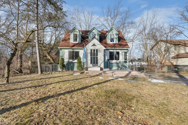 cape cod-style house featuring a front yard