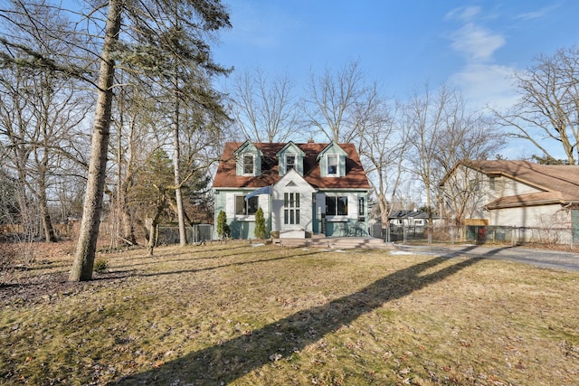 cape cod house with a front yard