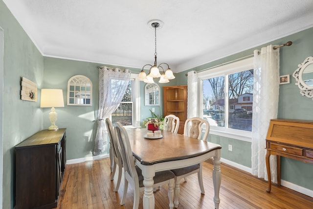 dining room featuring hardwood / wood-style floors, a wealth of natural light, and a chandelier