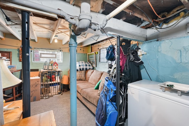 basement with light colored carpet and refrigerator