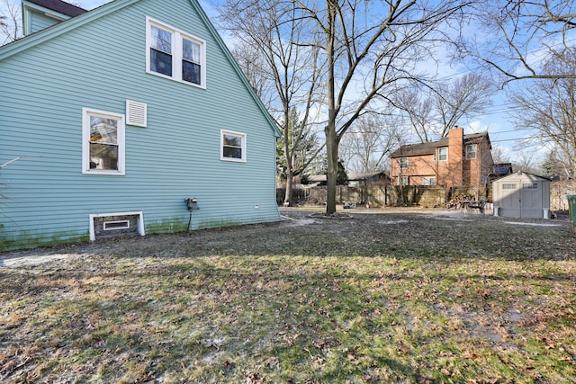 view of home's exterior with a storage shed and a yard