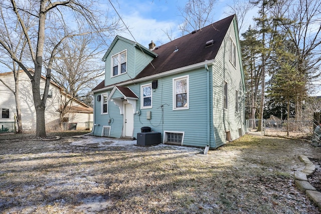 rear view of house featuring central AC unit