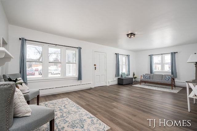 living room featuring a baseboard heating unit and hardwood / wood-style floors