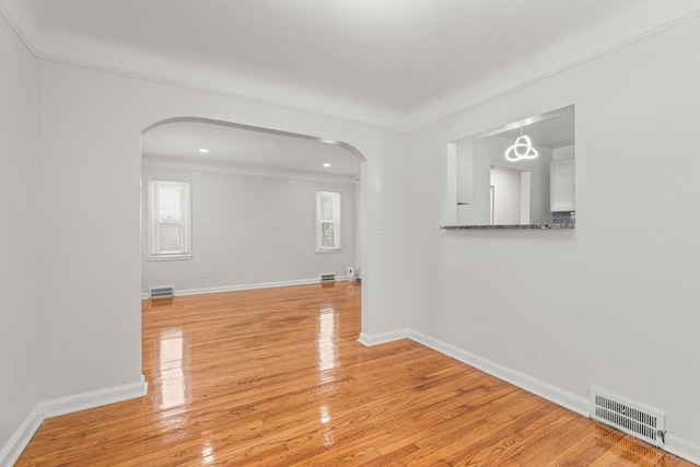 empty room with light hardwood / wood-style flooring