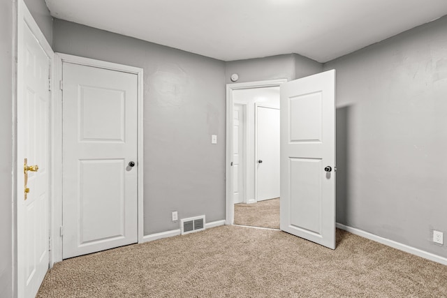 unfurnished bedroom with light colored carpet